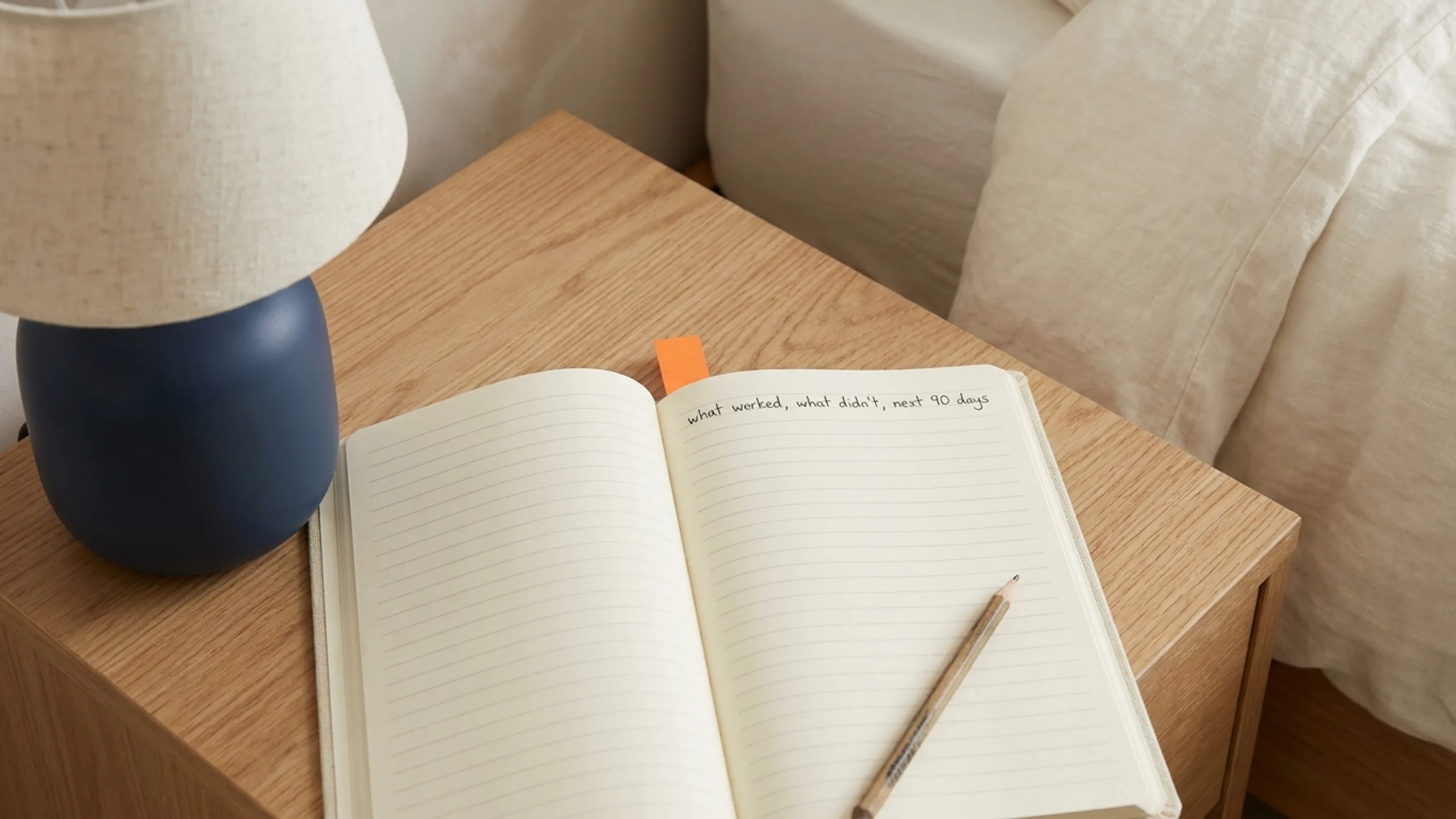 Open notebook on a nightstand with a single reflective sentence for dealcheck review
